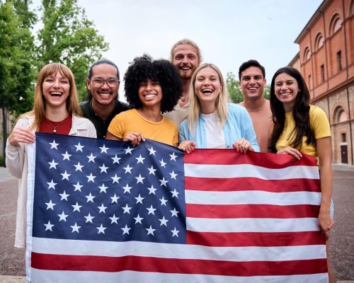 multiracial-group-of-friends-holding-american-flag-2025-06-05-23-17-14-utc(1)